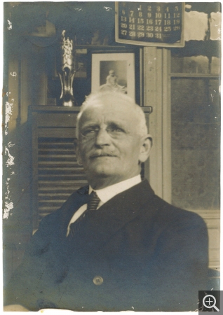 Félix Arnould, grand-père de Reynold, vers 1920, derrière lui, la photo de son petit-fils. Photographie. Collection Rot-Vatin